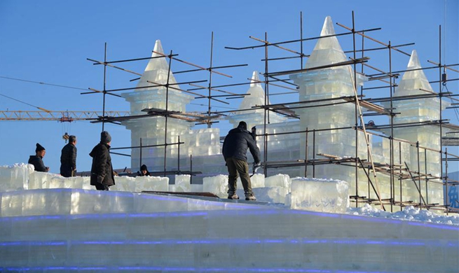 Workers make ice sculptures in Manzhouli for China-Russia-Mongolia ice snow festival