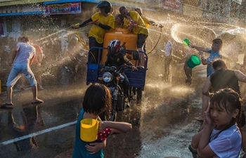 People splash water to celebrate Chinese Lunar New Year in Indonesia